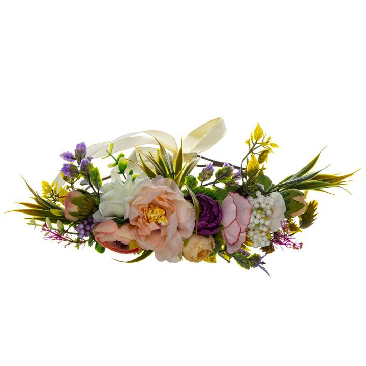 A romantic floral wreath in shades of peach and violet