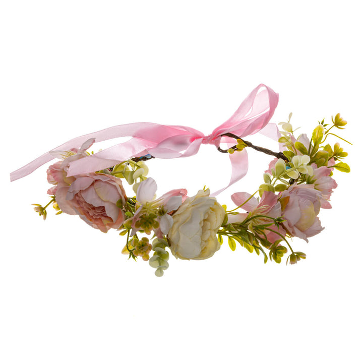 A light pink floral wreath with a white rose