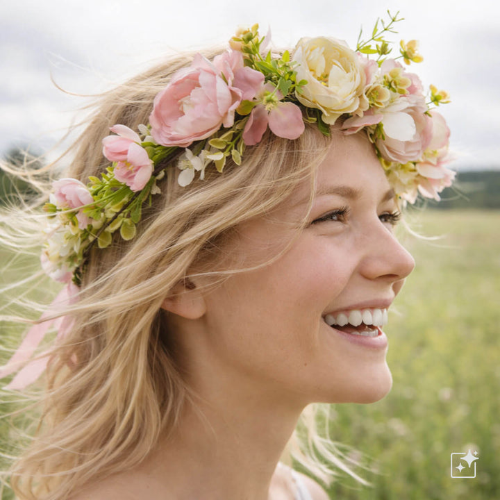 A light pink floral wreath with a white rose